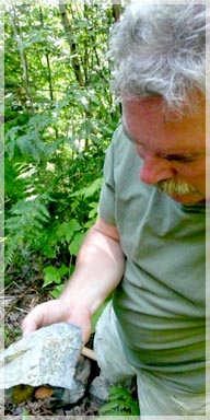 Bruce Doyle inspecting rocks for mineralization